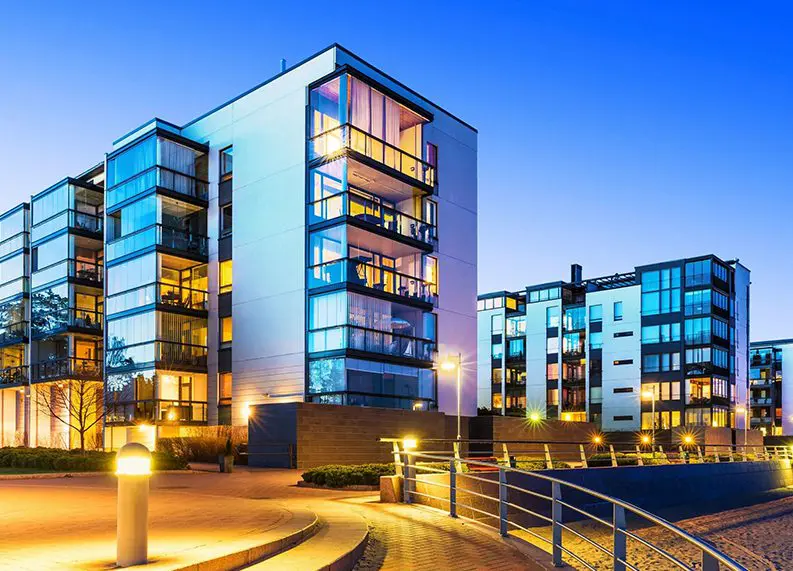 A building with many windows and lights on the outside.