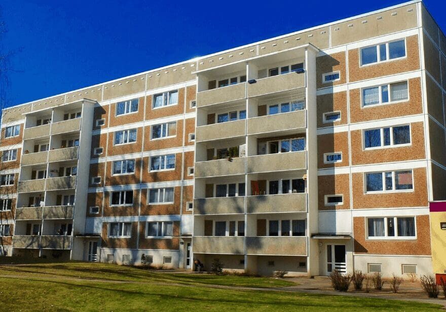 A large building with many windows and doors.