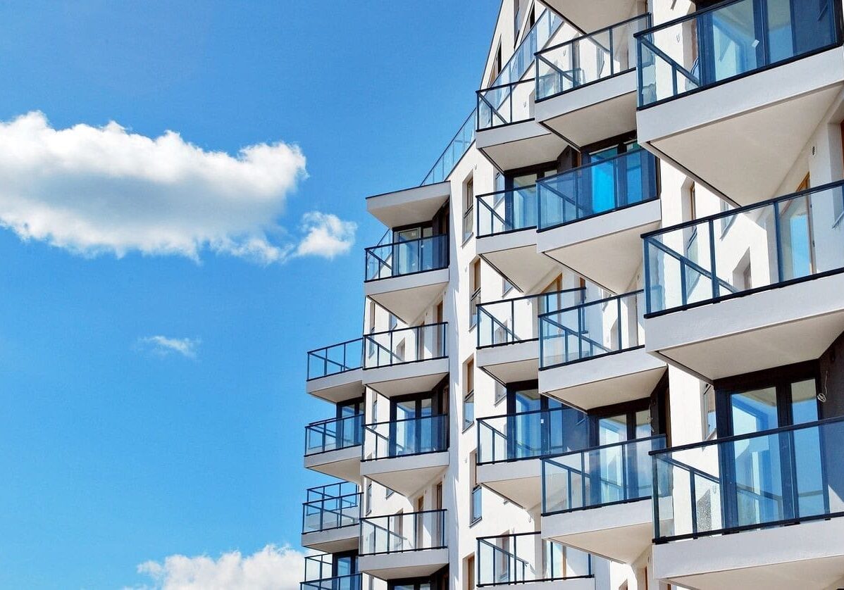 A building with balconies and windows on the outside.